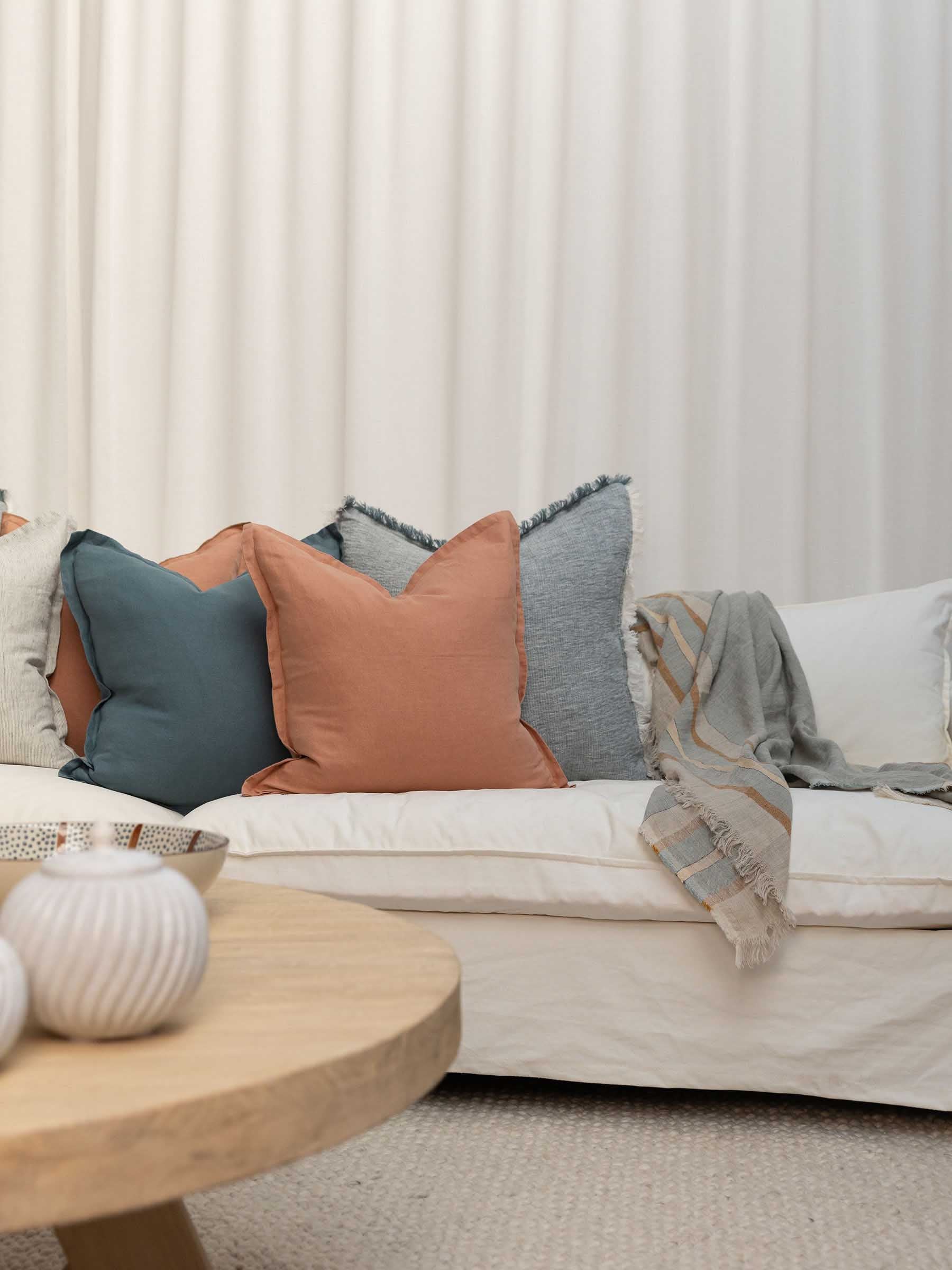 Arlo seagrass colour stripe throw styled in living room made from French flax linen with a herringbone weave and fringed edges