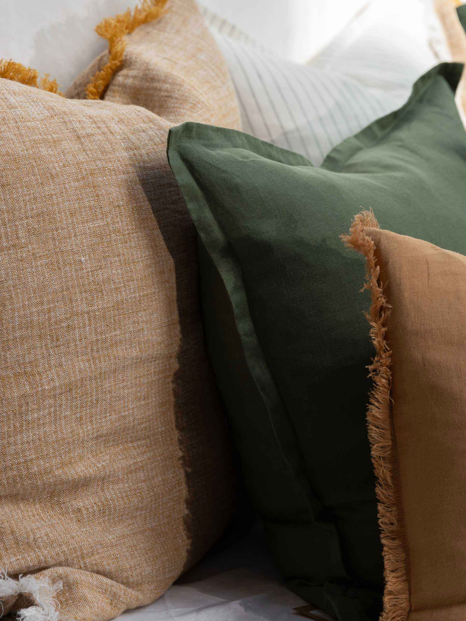 Close up of Felix Basil green cushion showing its soft french flax linen material and elegant flanged border