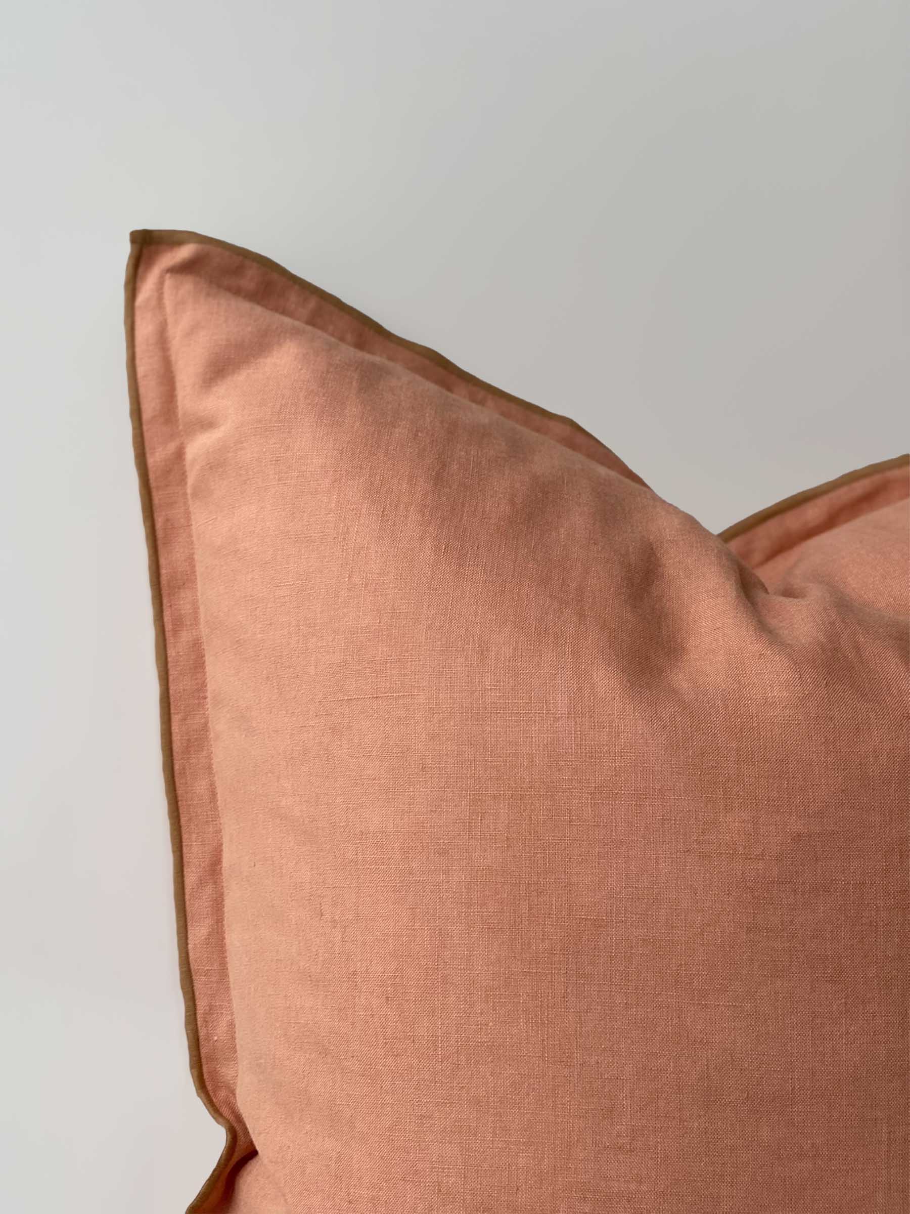 Close up detail of Harlow French Flax linen cushion in Clay colour showing butterscotch overstitching trim