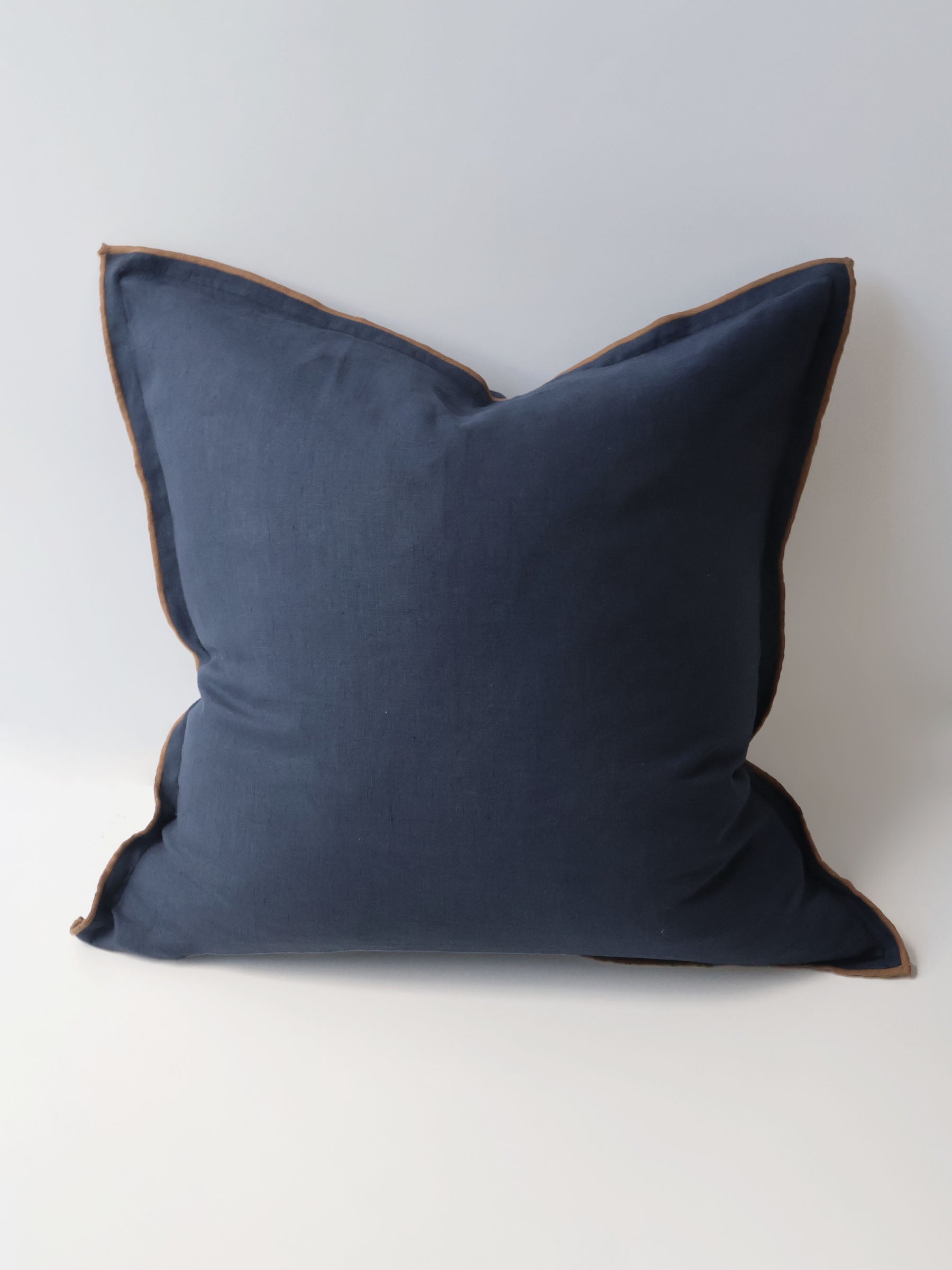 Harlow cushion in Navy colour 50cm square with overstitching trim in contrasting colour butterscotch made from French Flax linen