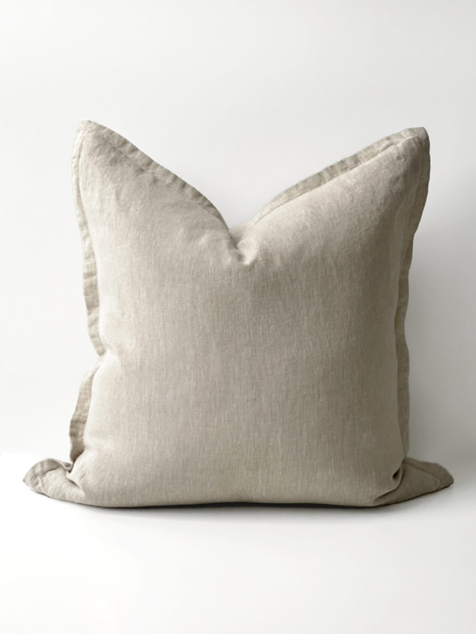 Reversi® reversible linen flange square cushion flipped to show full natural colour of the two in one cushion cover design in a studio