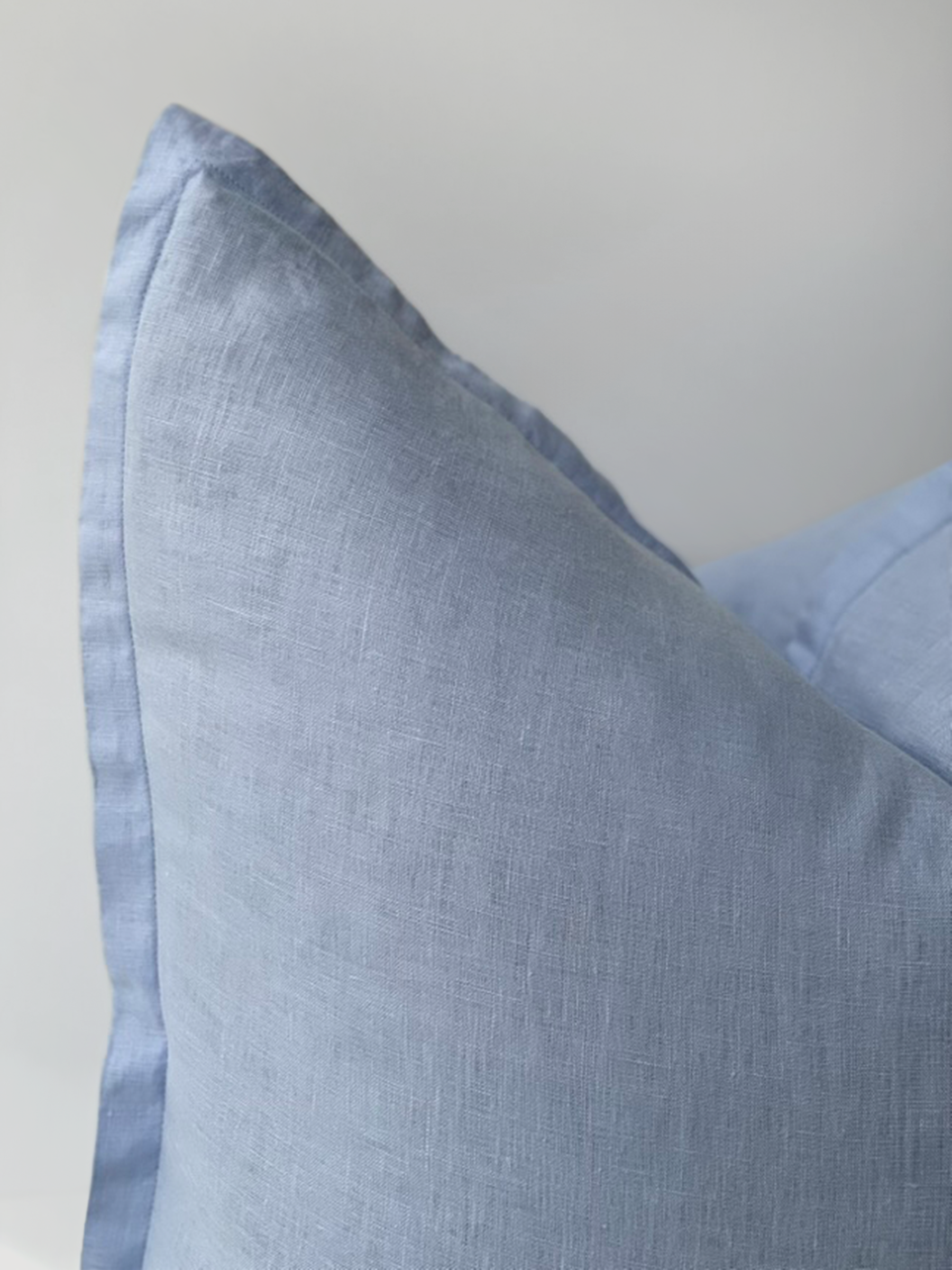 Reversi® reversible linen flange square cushion flipped to show sky colour texture close up of the two in one cushion cover design in a studio