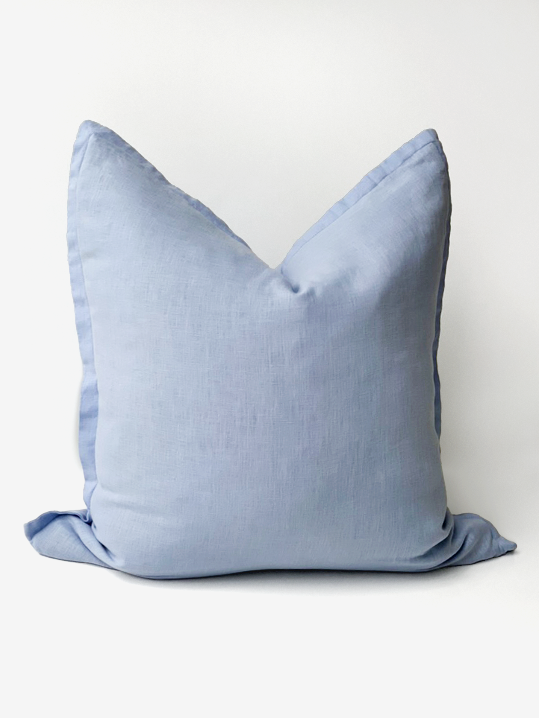 Reversi® reversible linen flange square cushion flipped to show full sky colour of the two in one cushion cover design in a studio