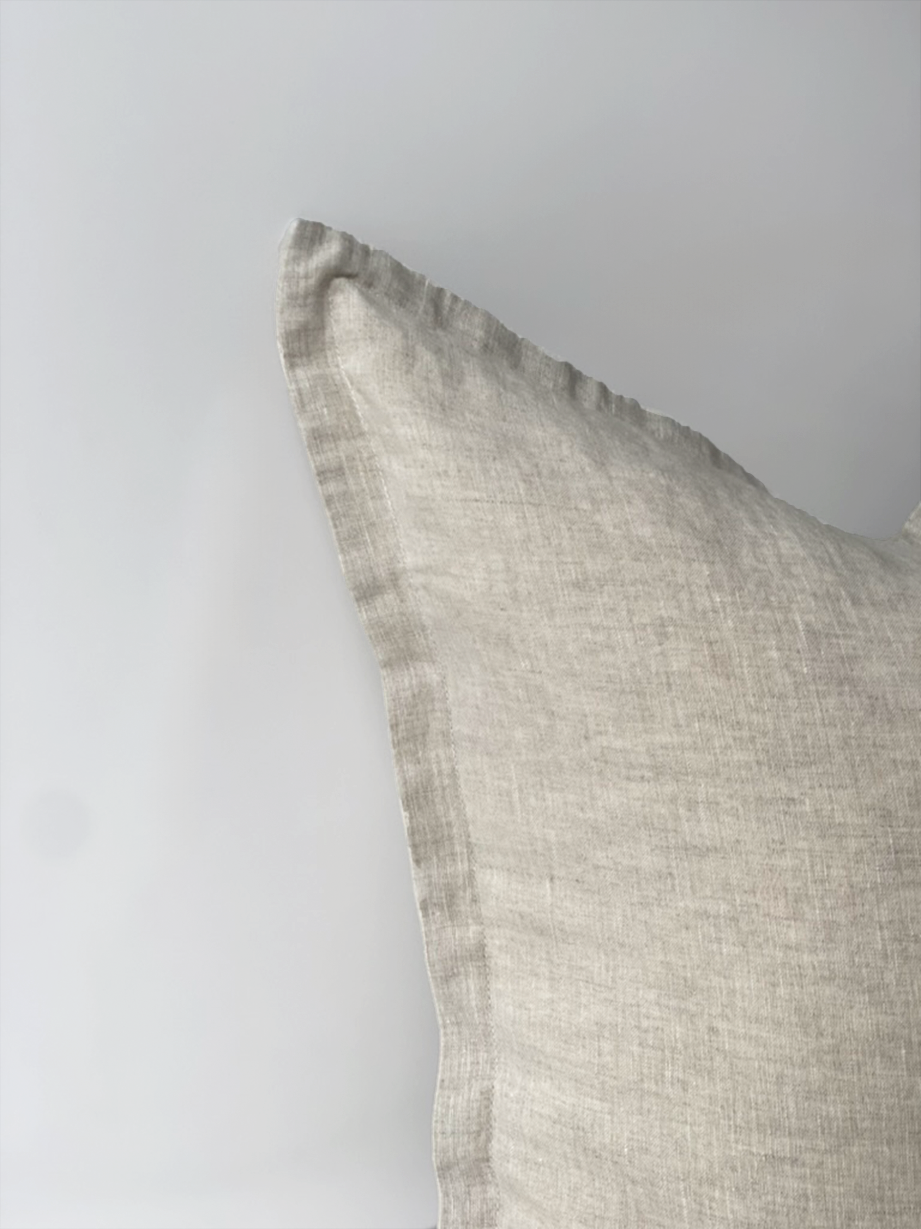 Reversi® reversible linen flange square cushion flipped to show natural colour texture close up of the two in one cushion cover design in a studio