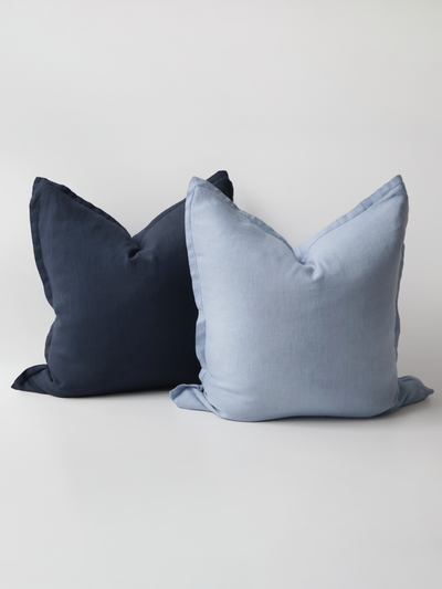 A video demonstration showing the Reversi® reversible linen flange square cushion design in sky and navy and how it flips inside out for a whole new look